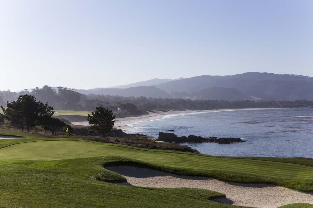 Pebble Beach golf course sand trap and putting green with ocean in background