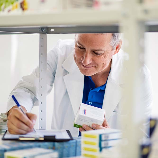 services-pharmacy-01 Male pharmacist checking medicines inventory at hospital pharmacy